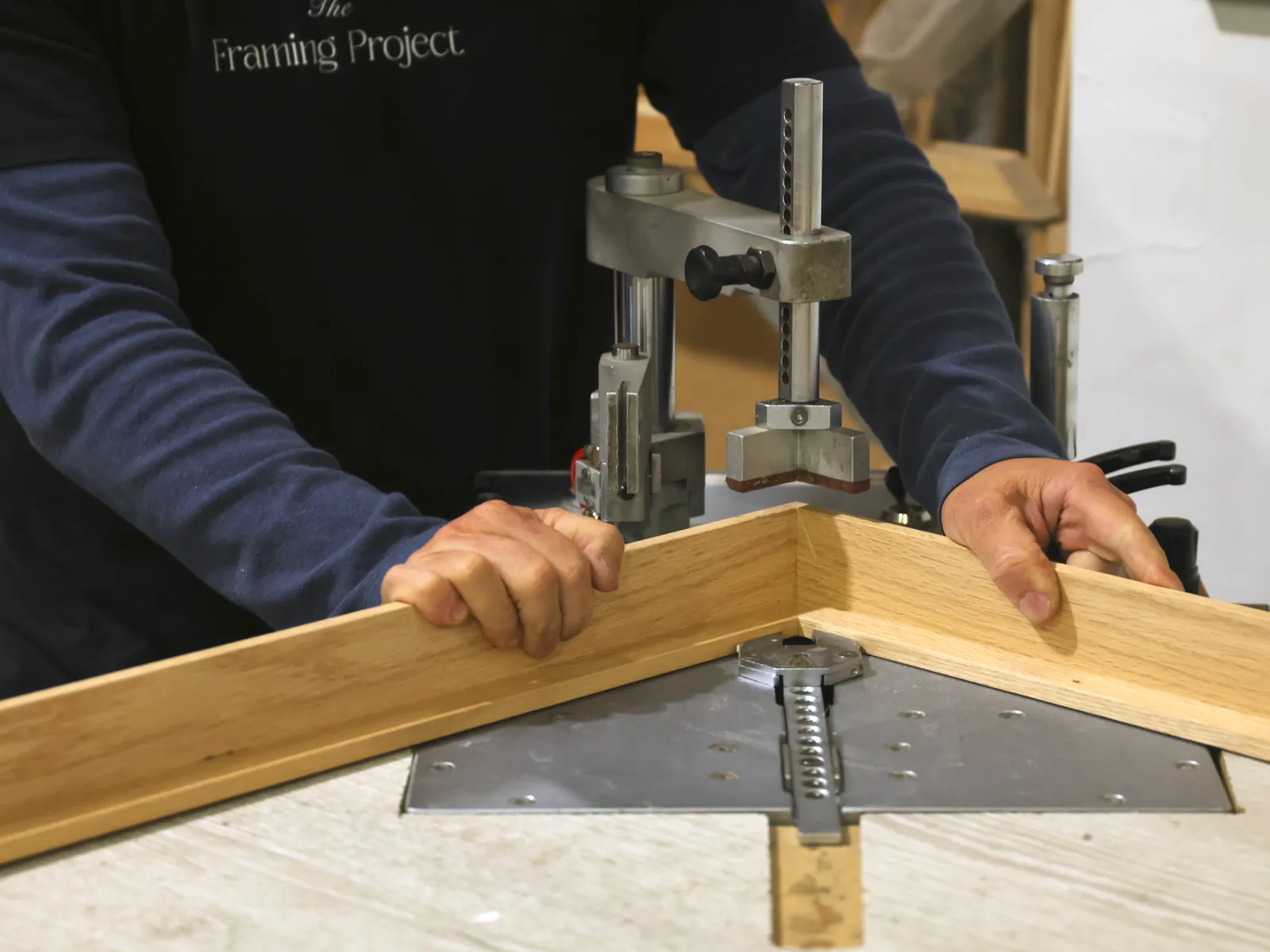 A framer joining the corner of an oak frame on the underpinner